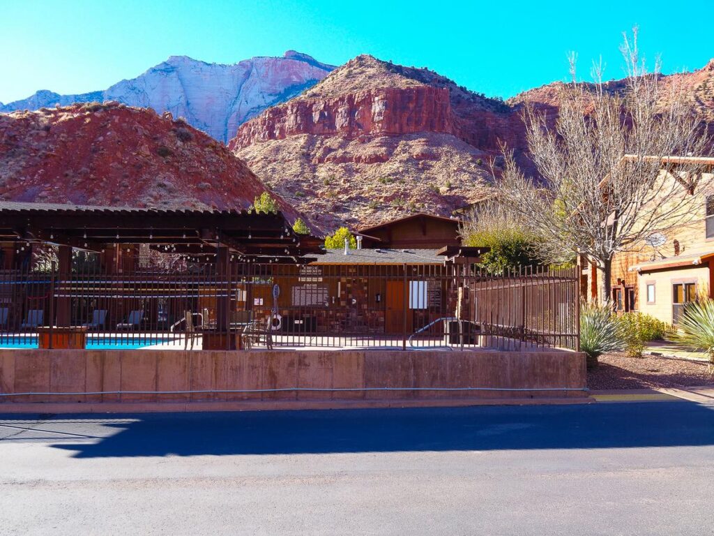 A serene outdoor swimming pool at Cable Mountain Lodge with rustic wooden structures