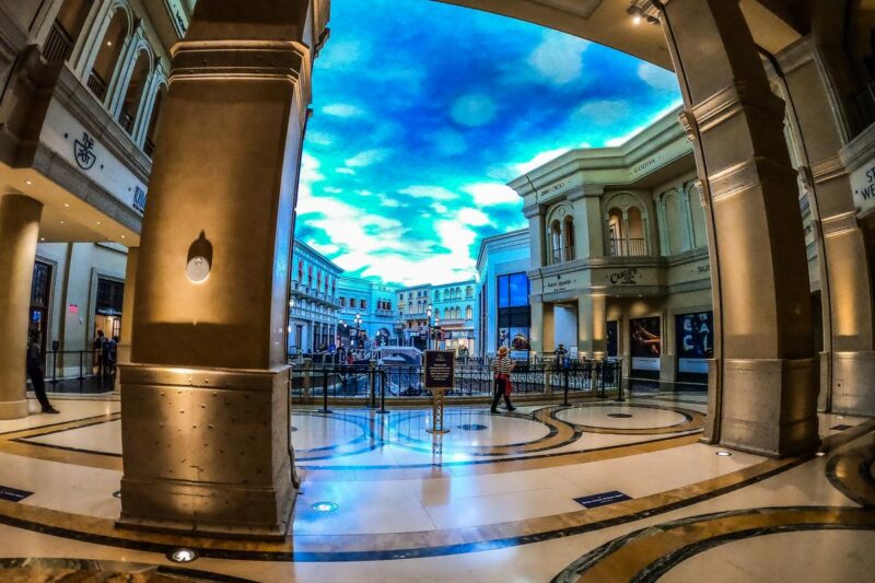Wide-angle view of Shoppes at the Venetian Las Vegas under a painted sky, luxury shopping experience