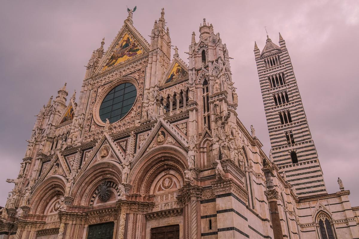 Siena Cathedral Gothic facade under dramatic clouds