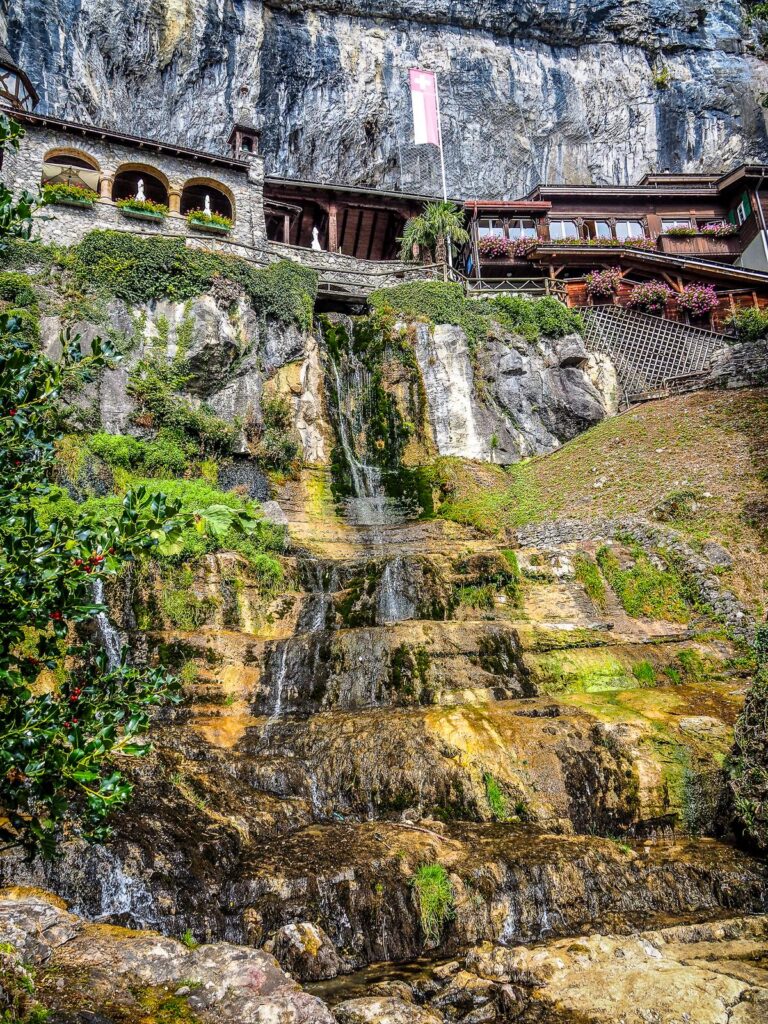 St. Beatus Caves entrance and waterfall in the Swiss Alps