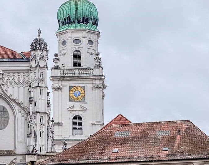 St. Stephen's Cathedral clock tower in Passau, Germany, showcasing historic architecture and scenic views