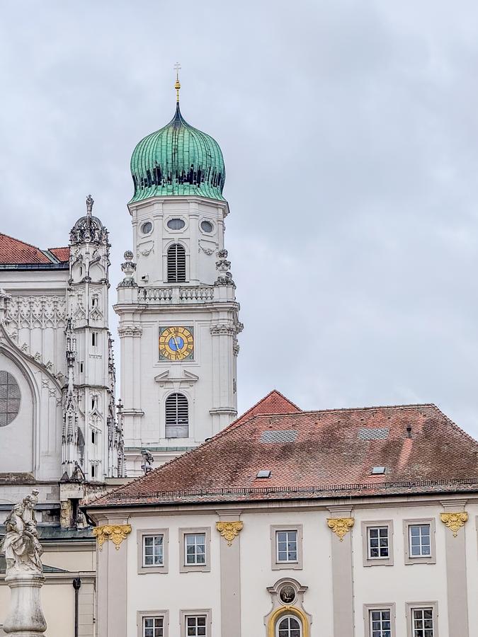 St. Stephen's Cathedral clock tower in Passau, Germany, showcasing historic architecture and scenic views