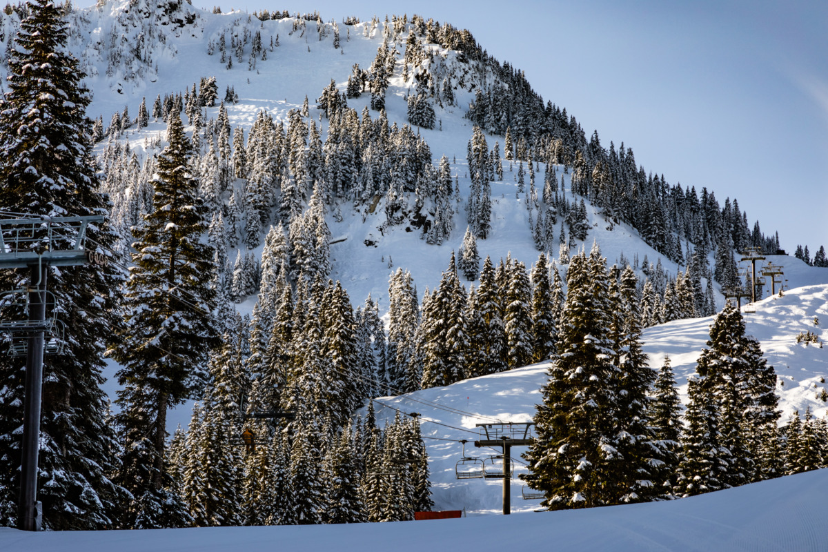 Skyline chair lift and snow-covered mountains in Stevens Pass Ski Resort