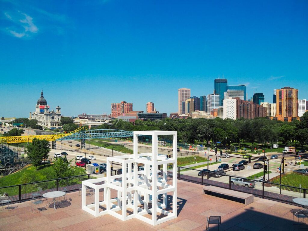 Stunning Minneapolis skyline view from Walker Art Center rooftop with vibrant urban panorama and architectural elements.