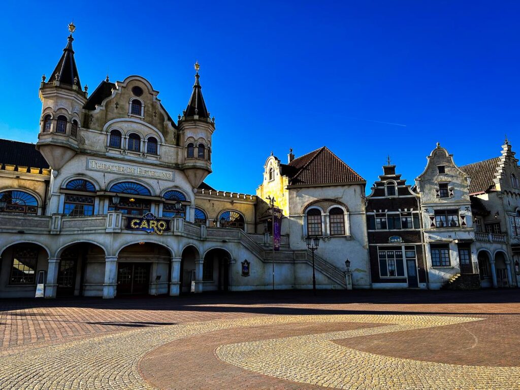 Sunlit Efteling Theatre, Netherlands, against deep blue sky.
