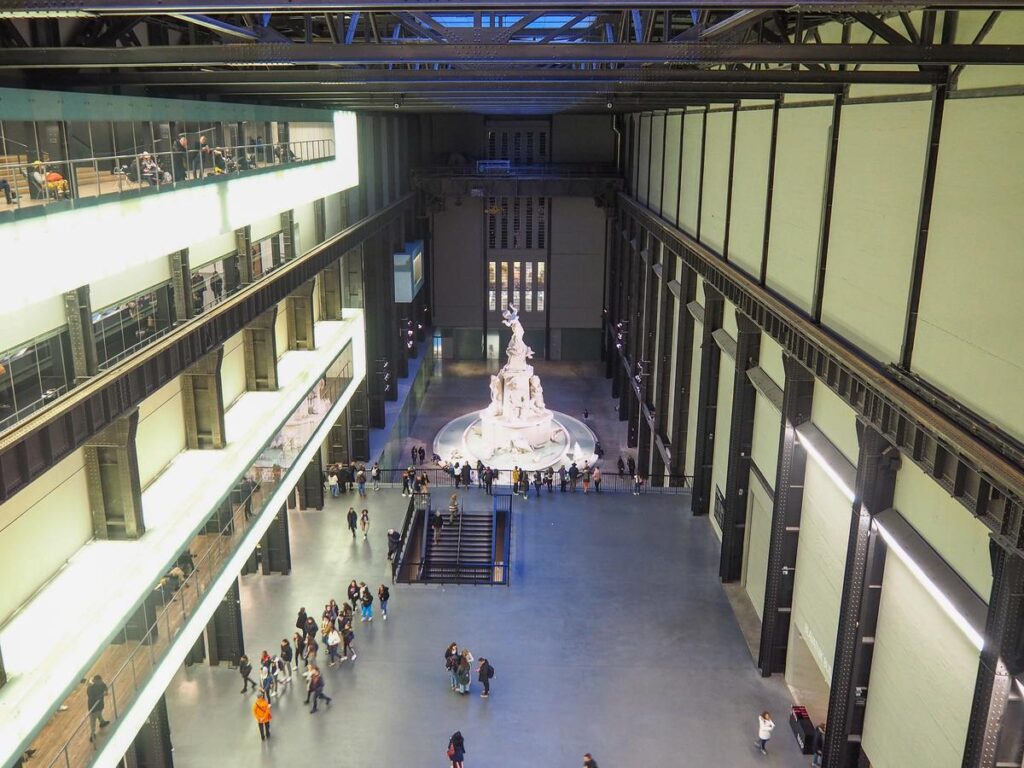 Interior of Tate Modern, London: Contemporary art gallery with spacious industrial design and vibrant atmosphere.