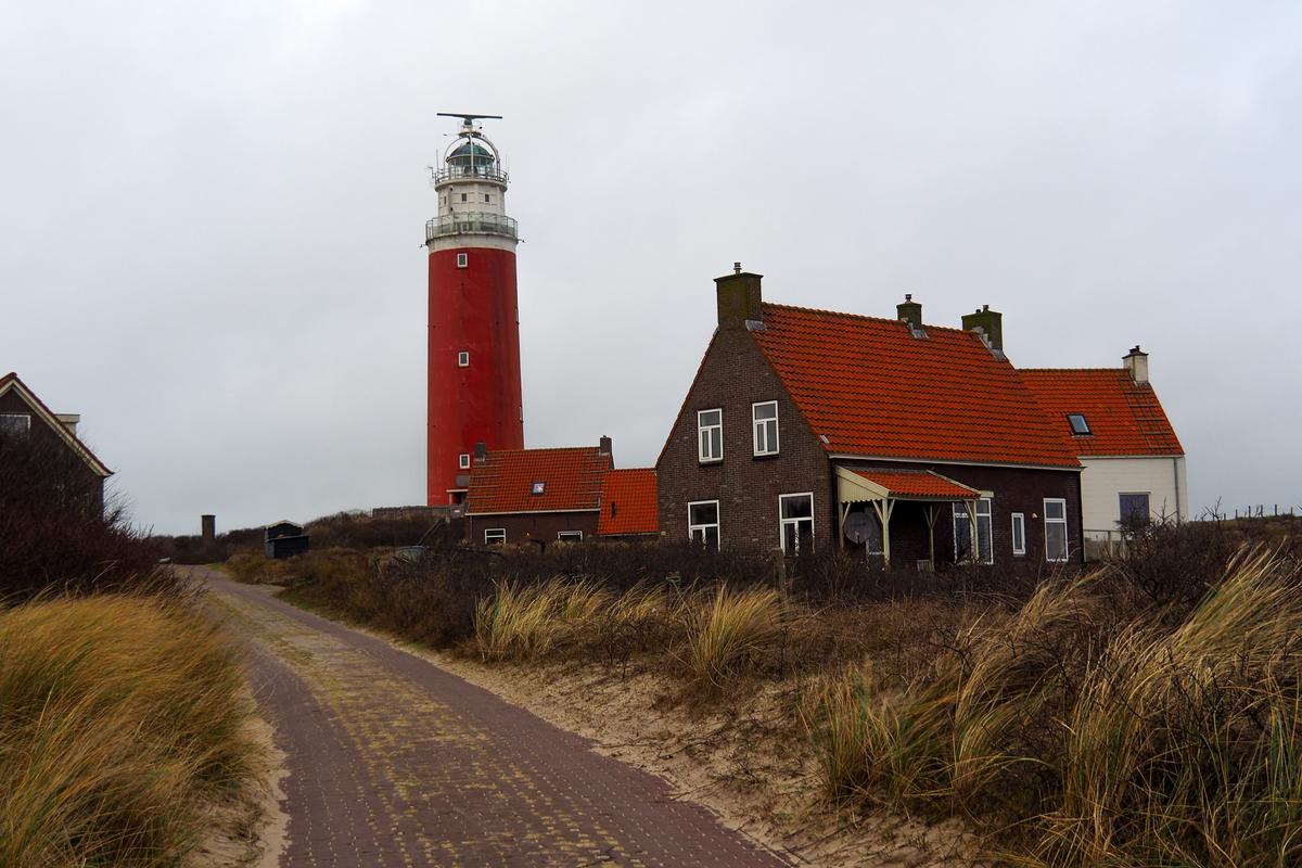 Red Texel Lighthouse and coastal houses on Texel Island, Netherlands - Top travel destination