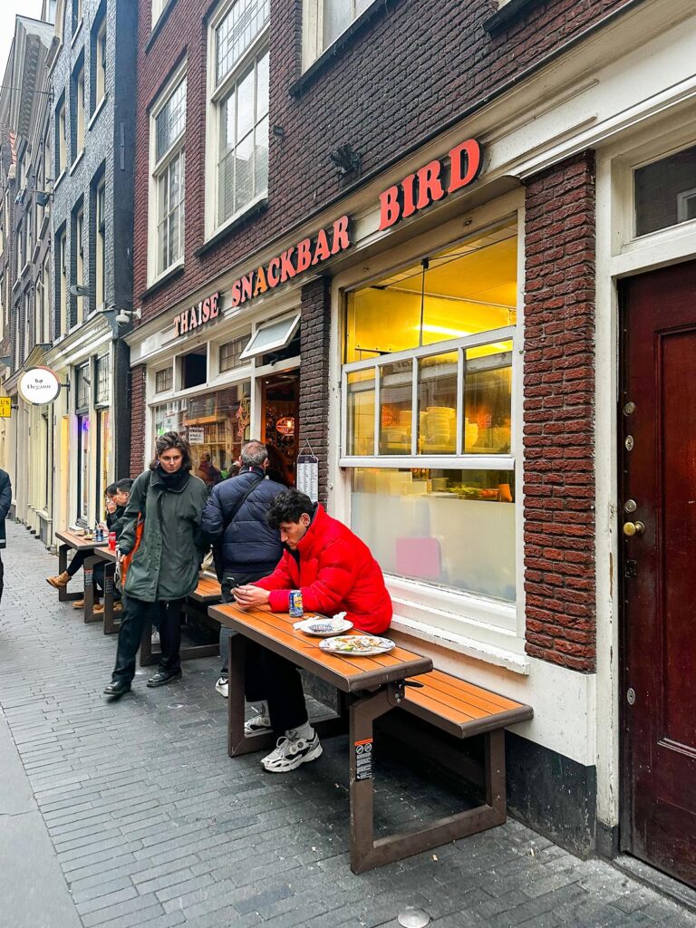 Diners enjoying Thai street food at Thaise Snackbar Bird in Amsterdam