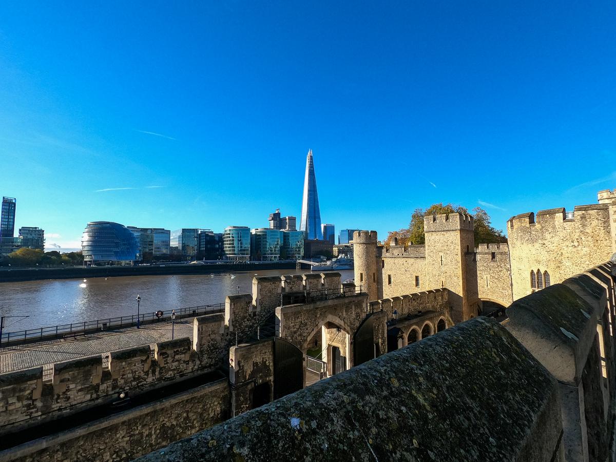 The Shard behind Tower of London walls with Thames River