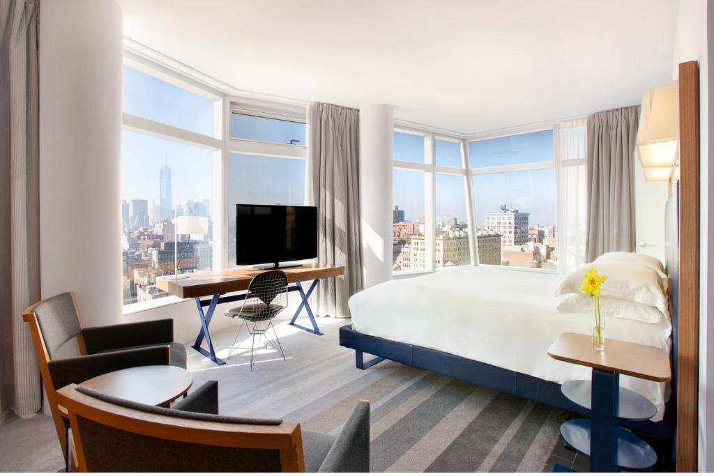 Modern guest room with floor-to-ceiling windows at The Standard East Village