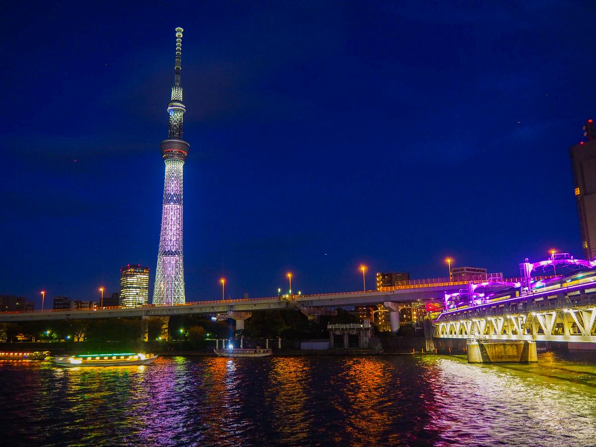 Tokyo Skytree illuminated at night, reflecting on Sumida River, Tokyo, Japan.