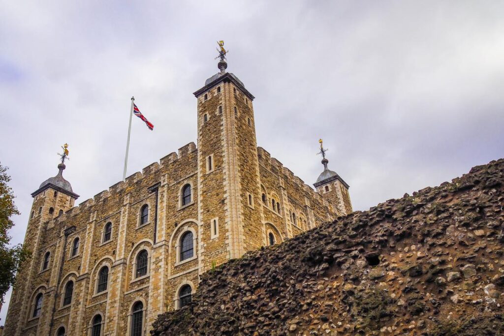 Tower of London architecture with Union Jack flag and weathervanes