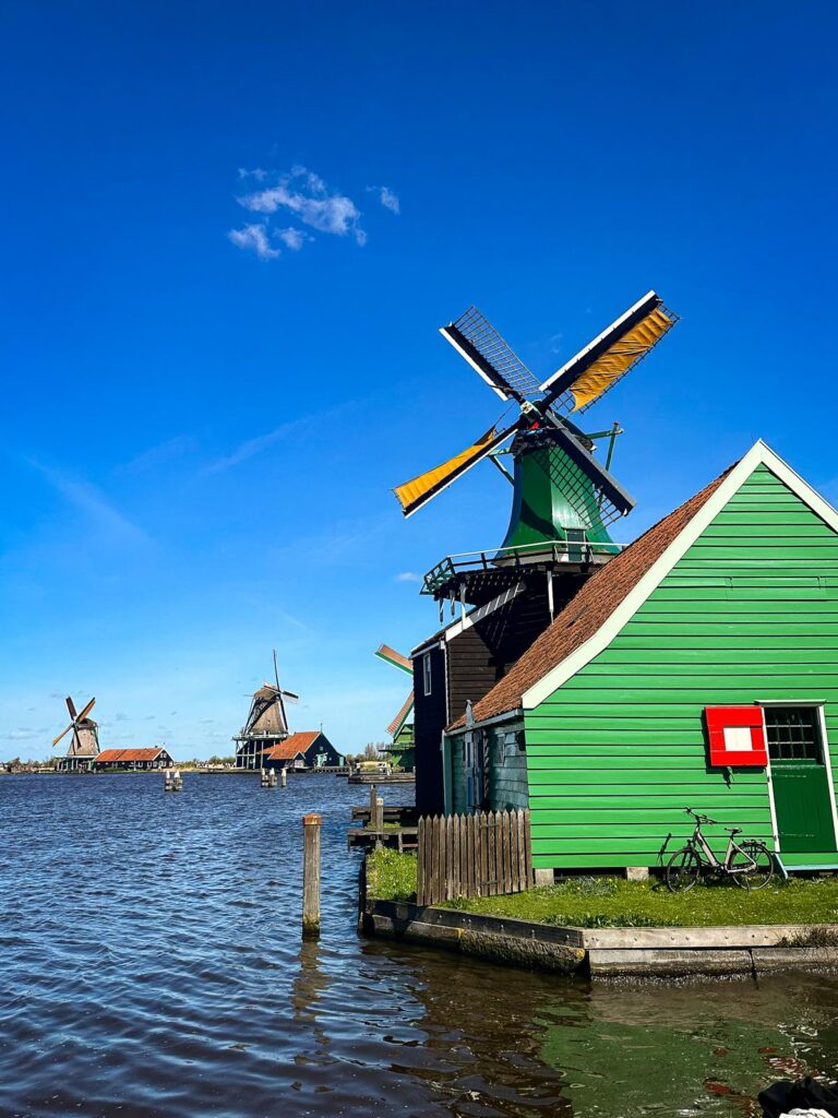 Traditional Dutch Windmills at Zaanse Schans, Netherlands - Iconic heritage scene with windmills, canal, and traditional architecture.