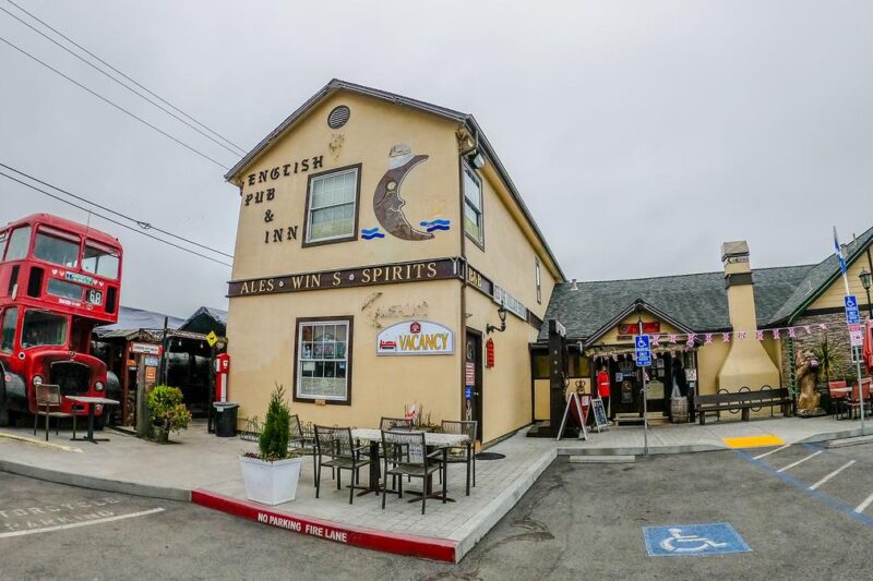 Traditional English Pub in Half Moon Bay with Red Double-Decker Bus