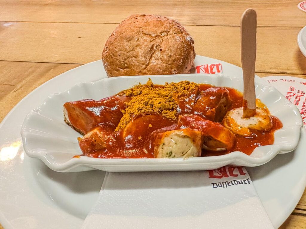 Traditional German currywurst and bread roll in Düsseldorf (source: [AIOSEO](https://aioseo.com/how-to-write-alt-text-for-images-for-seo-3-easy-tips/))
