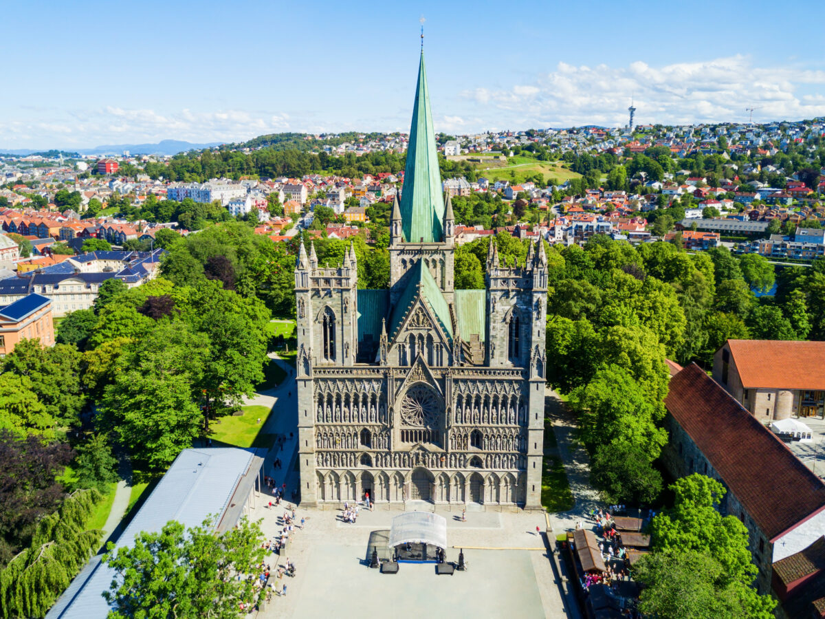 Aerial view of Nidaros Cathedral in Trondheim, Norway, showcasing Gothic architecture and verdigris spire.