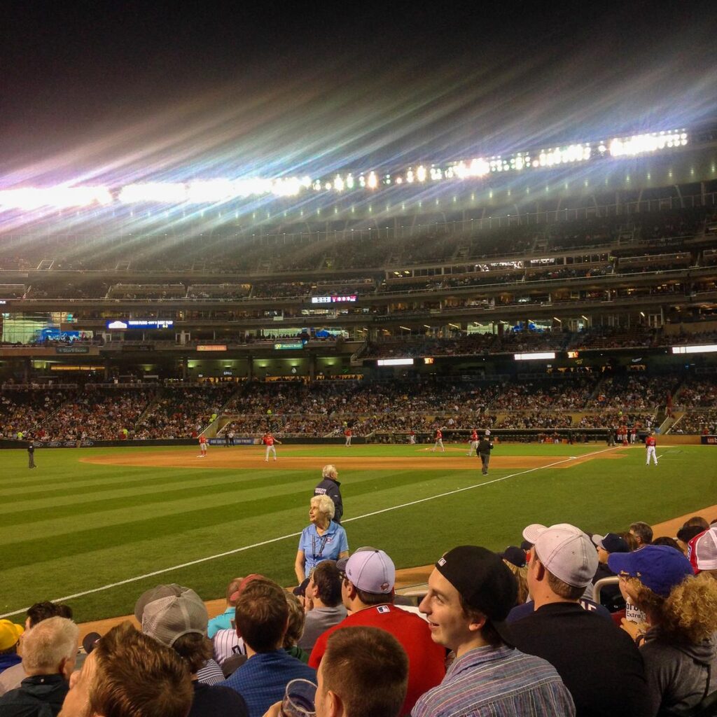 Twins baseball game at Target Field, Minneapolis, with enthusiastic fans and stadium lights