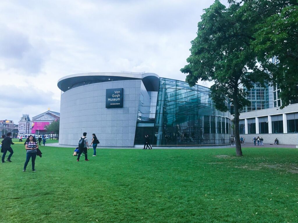 Visitors at Van Gogh Museum's modern exterior in Museumplein, Amsterdam, Netherlands