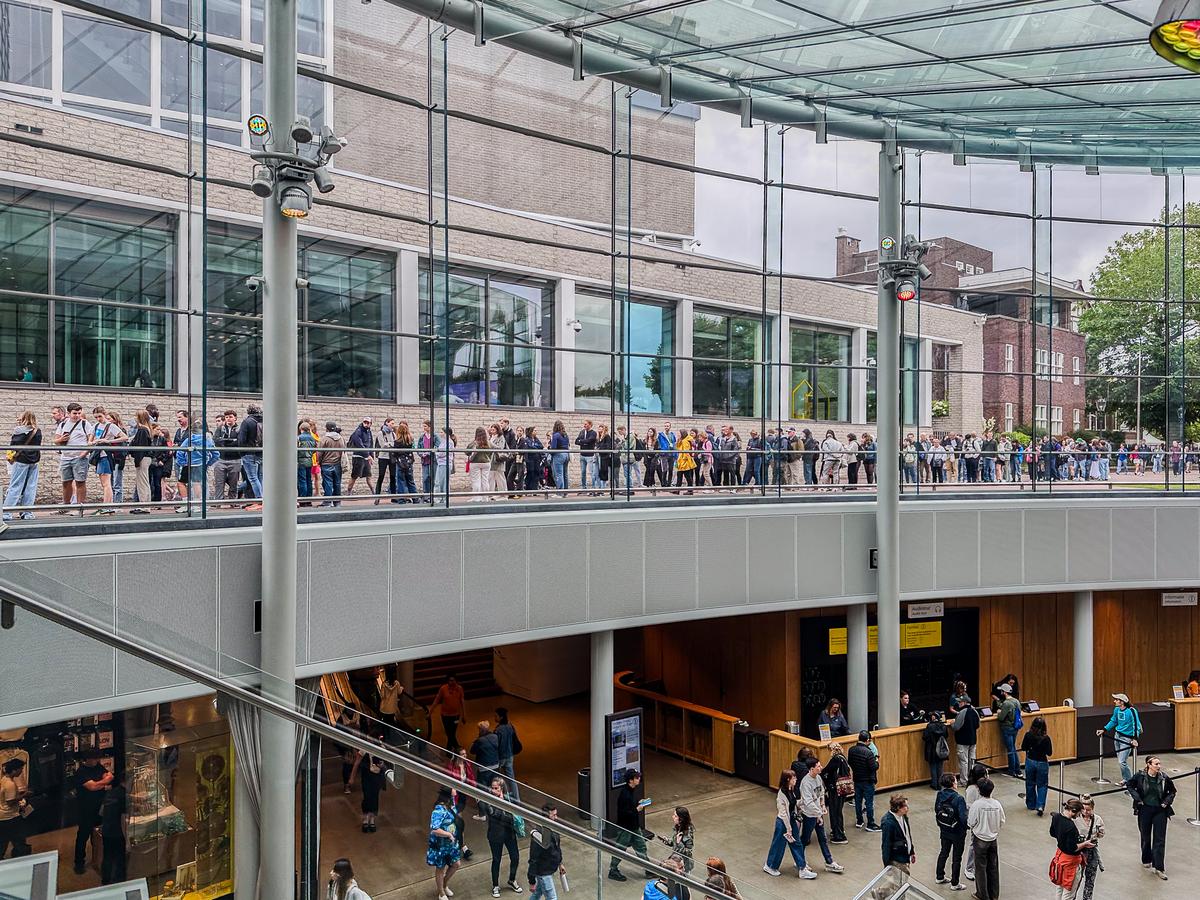 Van Gogh Museum entrance hall with visitors in Amsterdam, interior view, famous art museum