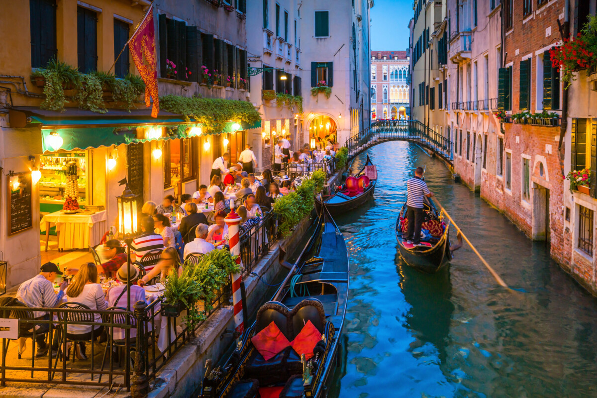 Grand canal and gondola ride at night in Venice, Italy