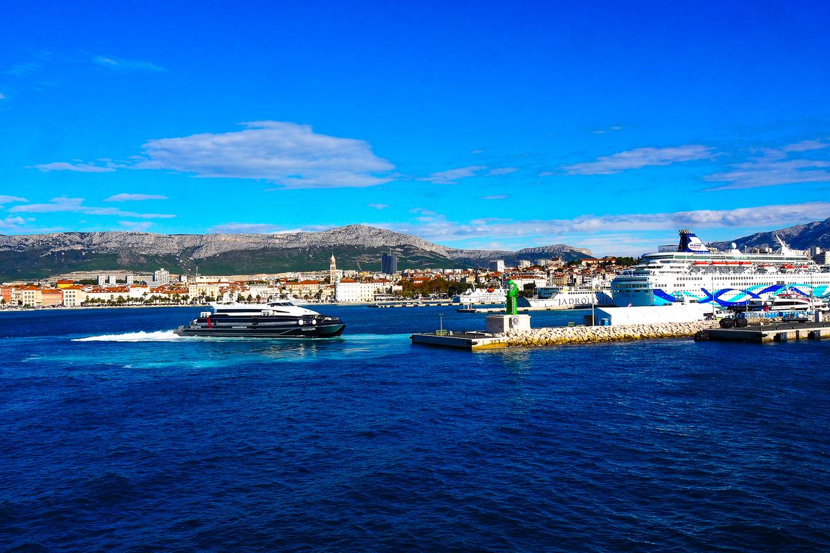 Maritime activity at Split Harbor, Croatia, with boats, ferry, and cruise ship