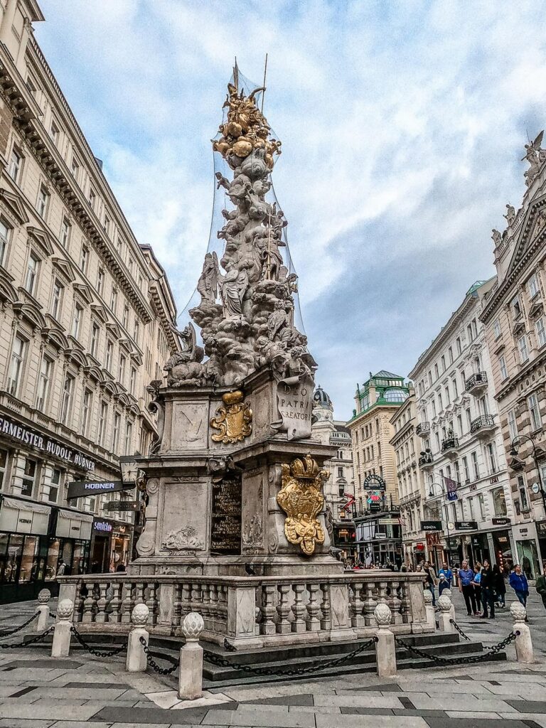 Baroque Vienna Plague Column with onlookers in city center