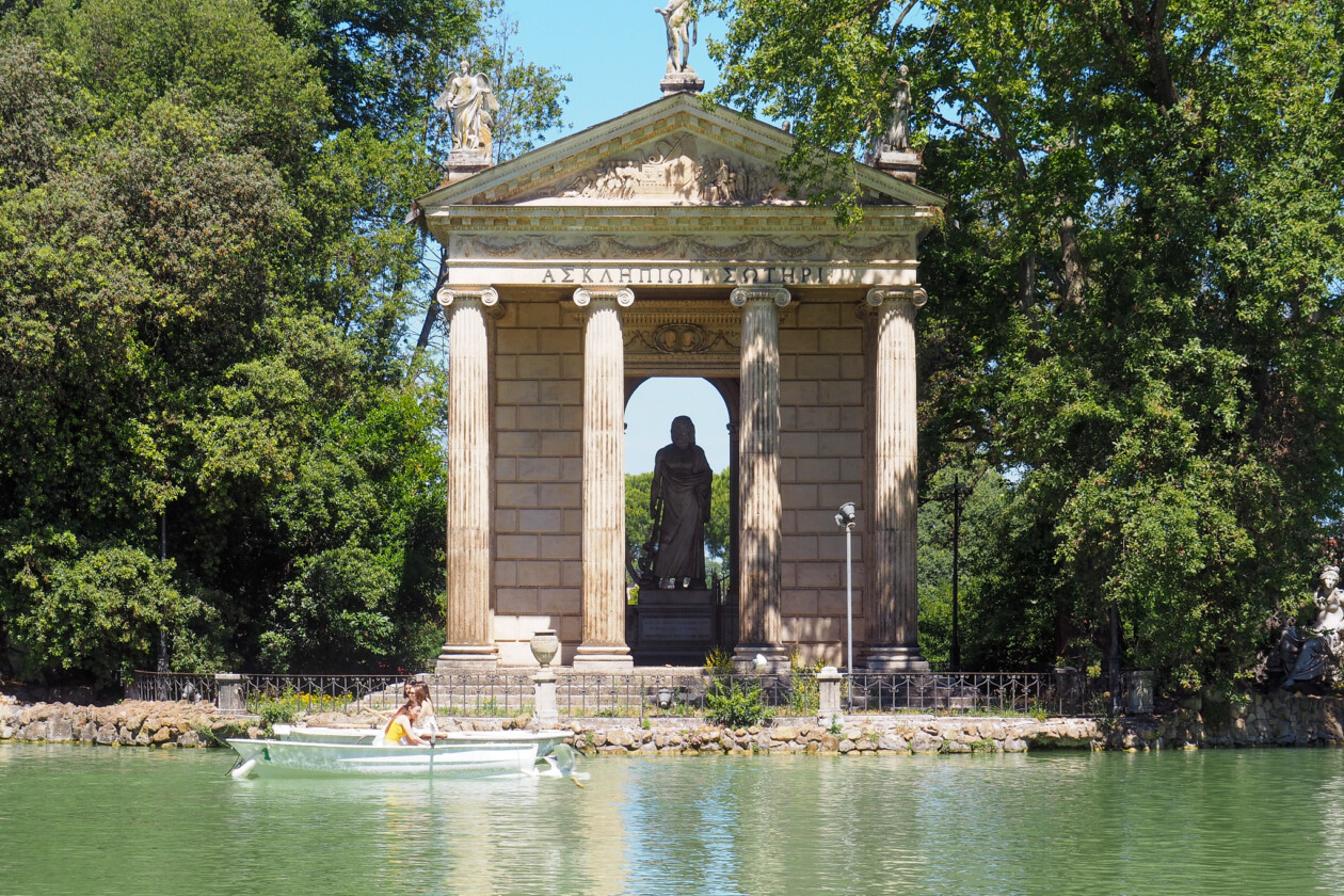 Temple of Aesculapius at Villa Borghese in Rome with lake rowboat.