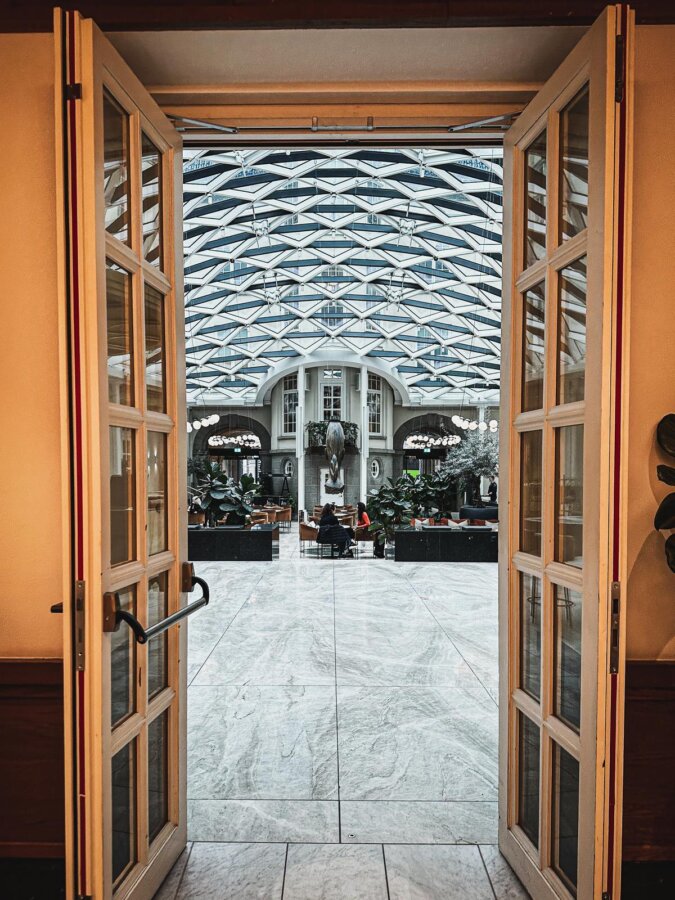 Elegant entrance of Villa Copenhagen with marble floors and glass ceiling