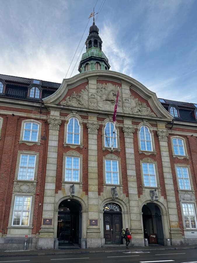 Villa Copenhagen exterior with iconic Danish architecture and blue sky