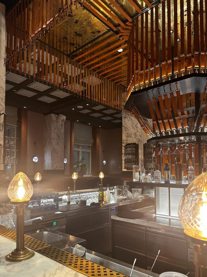 Luxurious Villa Copenhagen bar with vintage lighting and marble counters