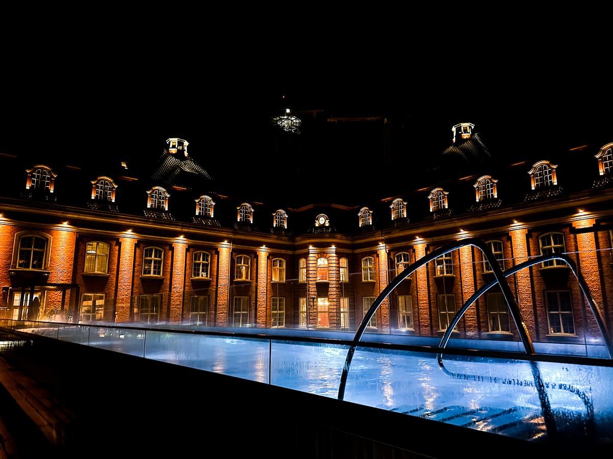 Night view of Villa Copenhagen's luxurious pool with light reflections