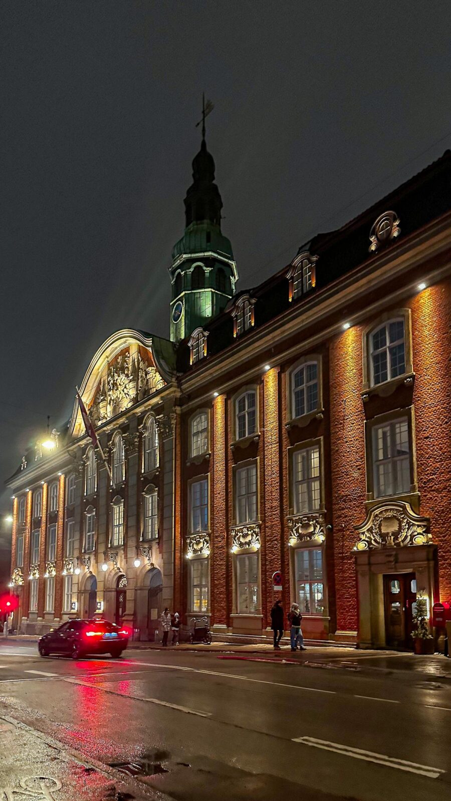 Illuminated brick facade of Villa Copenhagen at night