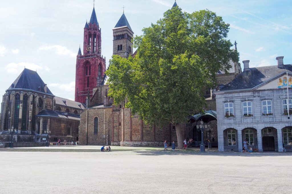 Exploring the Historic Vrijthof Square in Maastricht, Netherlands - Sunny day, historical landmarks, vibrant urban scene.