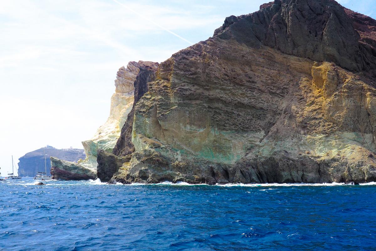 White Beach Santorini view from boat with crystal-clear waters and dramatic cliffs