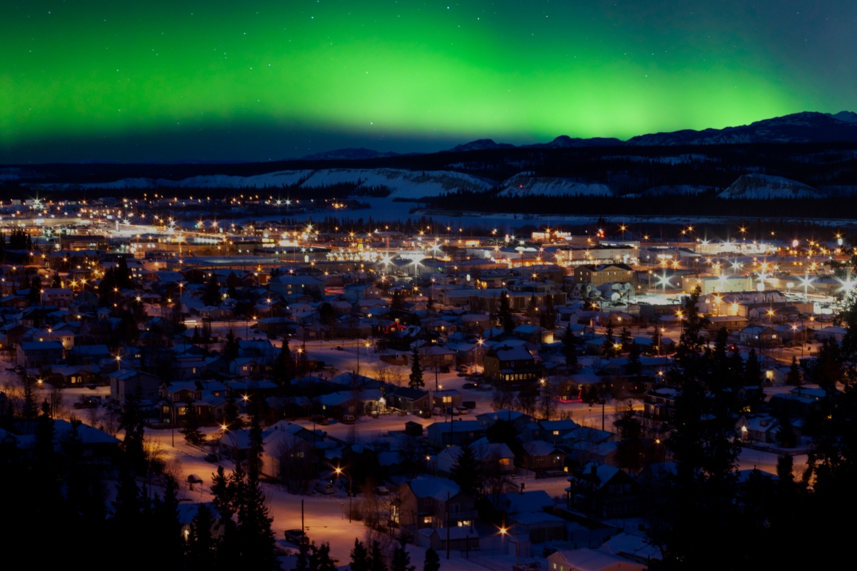 Panoramic view of the northern Lights over the Downtown Whitehorse in Yukon, Canada