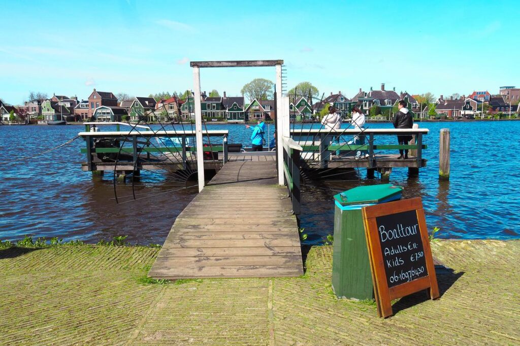 Zaanse Schans boat tour showcasing traditional Dutch architecture and serene waterway.